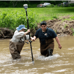 Uriel Vaca and QiFan Zhao measure the depth of a creek where they are building a bridge.
Zachary Turner/WFAE